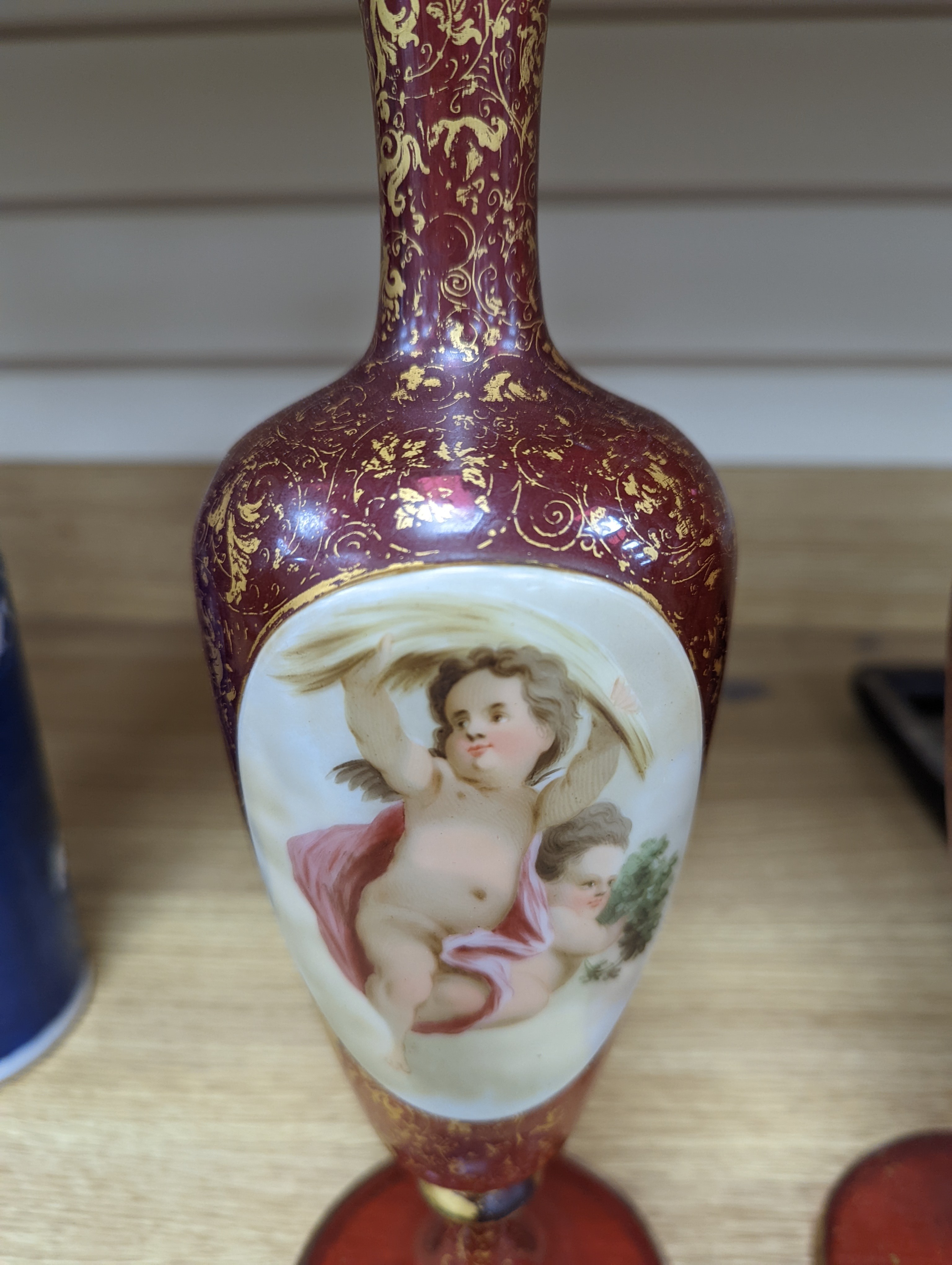 A pair of 19th century Bohemian enamelled and overlaid ruby glass vases 36cm